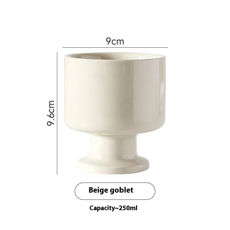 Hand-pinched irregular ceramic mug in a solid colour, shown from the side.