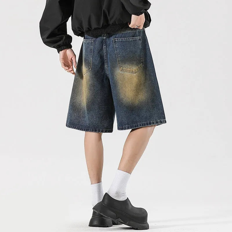 Men's retro blue loose-fit ripped jeans made from cotton denim, shown in a street style.