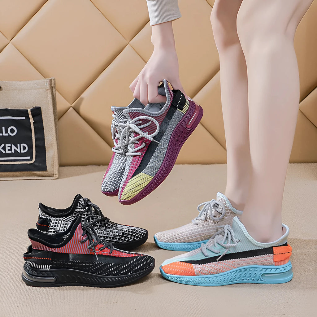 Women's purple low-top lace-up running shoes with round toe and plastic sole on a white background.