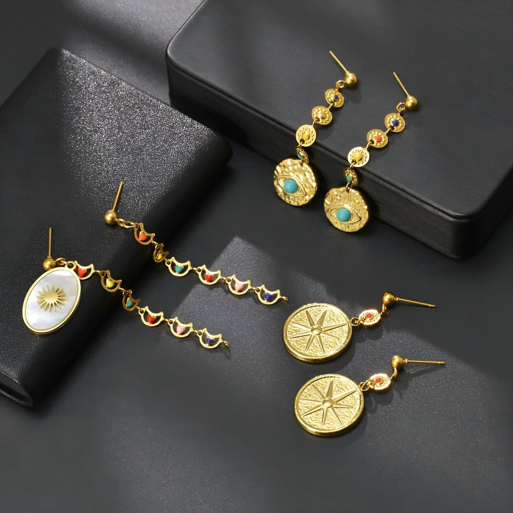 Stainless steel geometric drop earrings in Eight Awn Star, Eye, and Shell Sun designs.