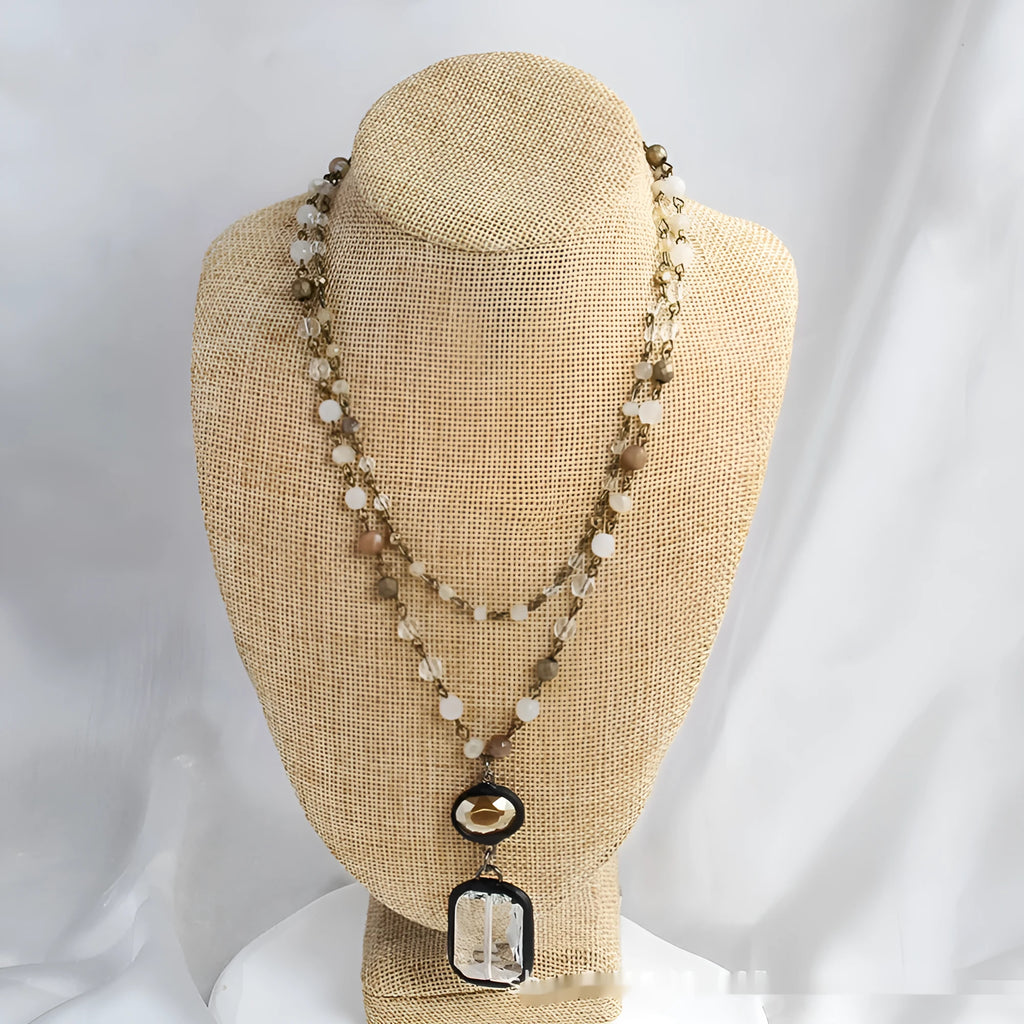Tribal-style retro necklace with a blue stone and glass pendant on a metal chain.