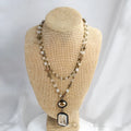 Tribal-style retro necklace with a blue stone and glass pendant on a metal chain.