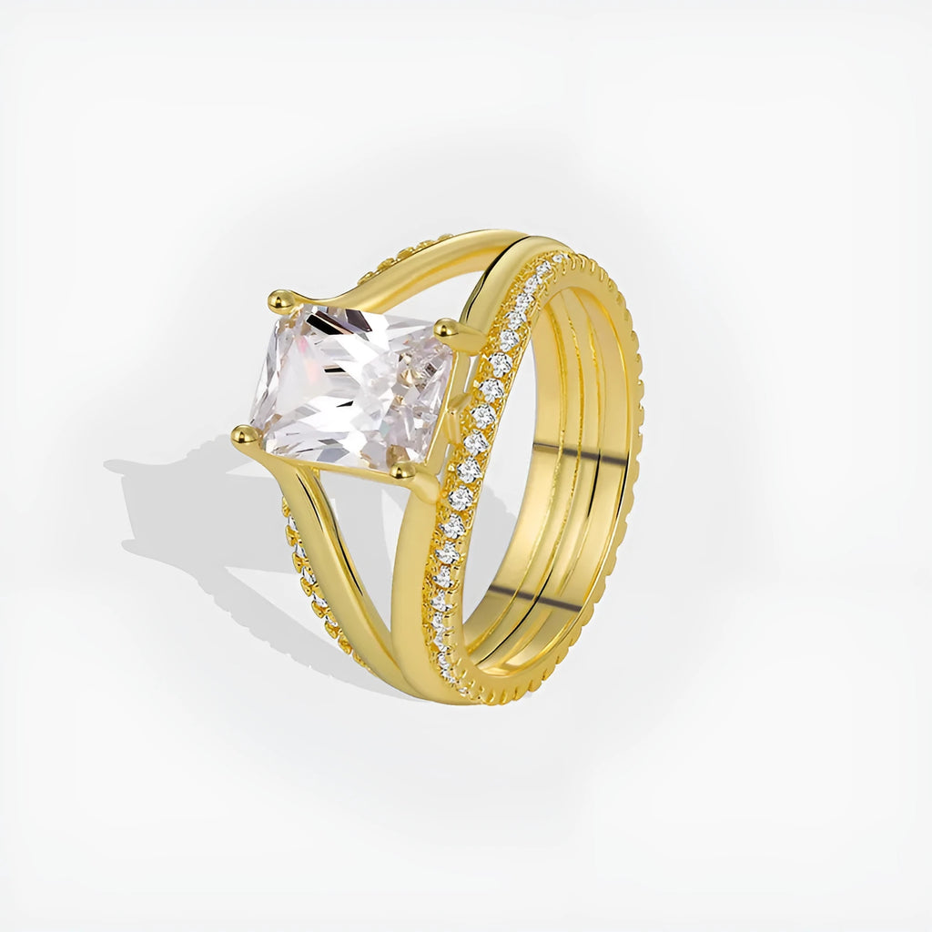 Gold-colour geometric women's ring with a square zircon centre, shown on a finger.