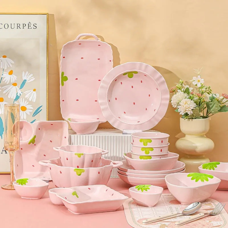 Cute strawberry-themed porcelain dinnerware set with flower bowl, straw hat plate, disc, and twist spoon.