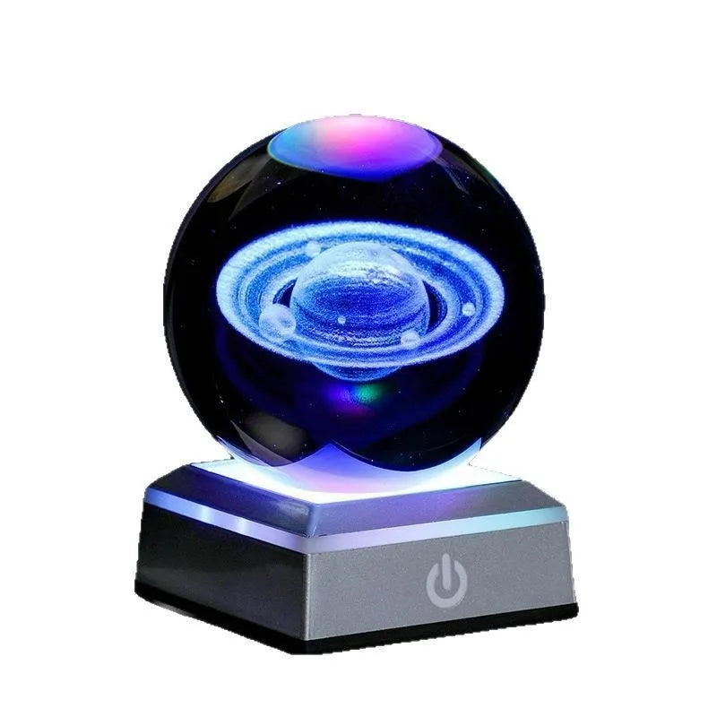 Transparent white crystal ball night light with 3D inner carving of Milky Way on black square colourful base
