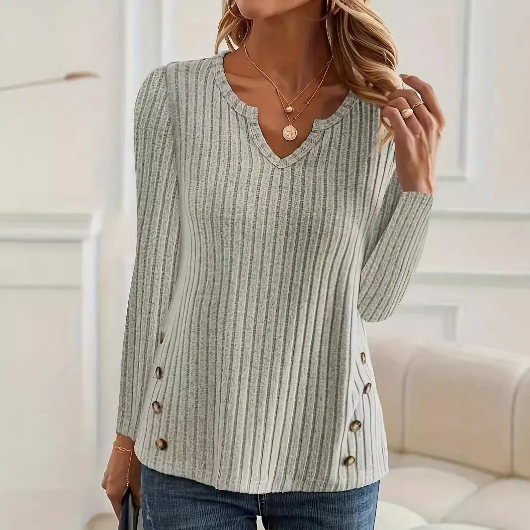 A solid colour casual knitted sweater with a button detail, shown in grey green.
