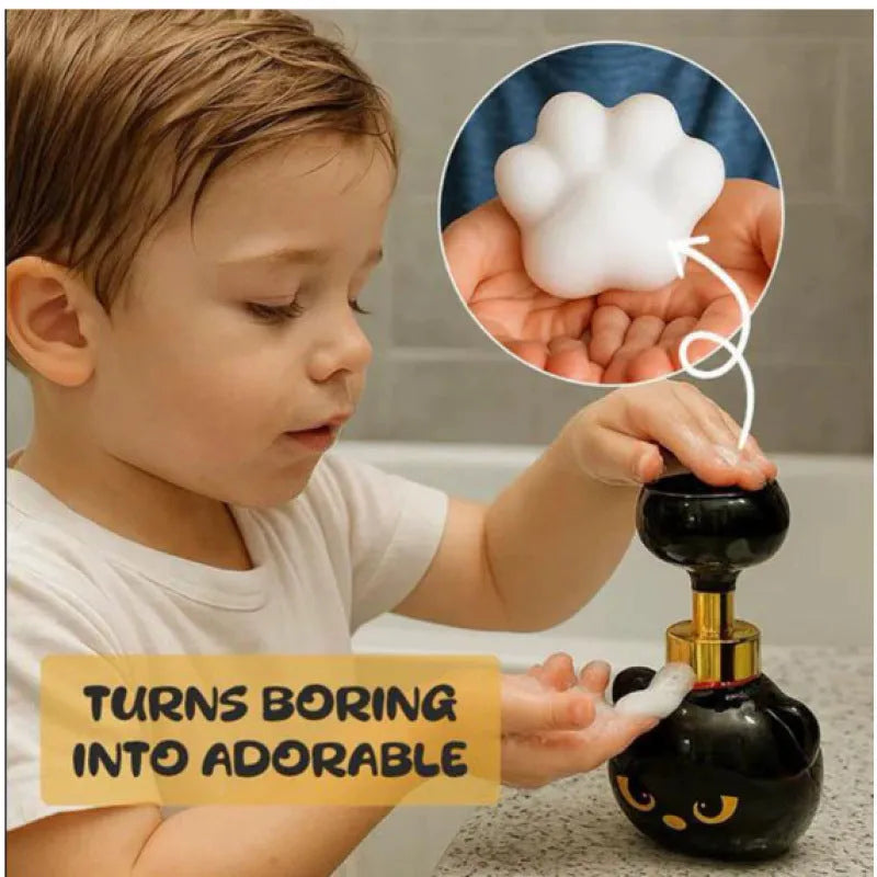 Black cartoon cat-shaped plastic foam soap dispenser on a bathroom sink.