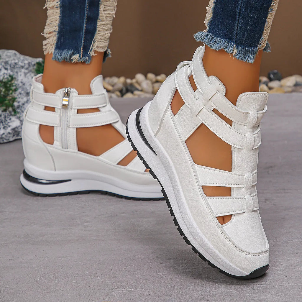 Women's black close-toed sandals with hollow-out patterning and platform sole, showing Velcro fastening