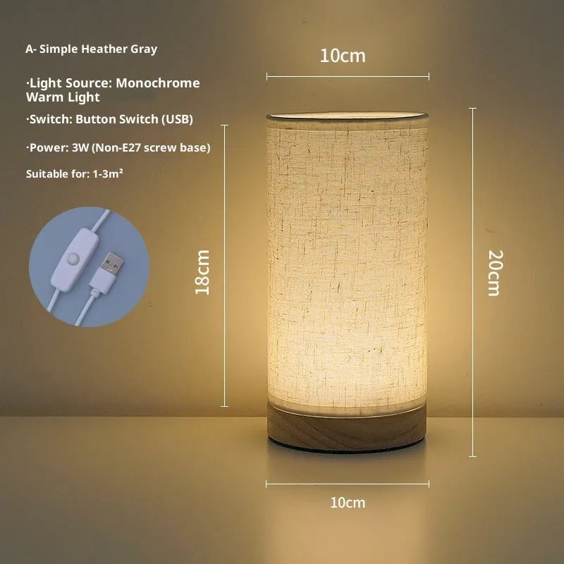 Creative floral fabric table lamp with remote control, warm LED light, black oil painting pattern on a bedside table