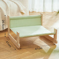 Wooden elevated cat bed hammock with cloth cushion in blue or green colour.