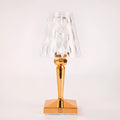 Portable rose gold touch projection night light with rechargeable battery on bedside table