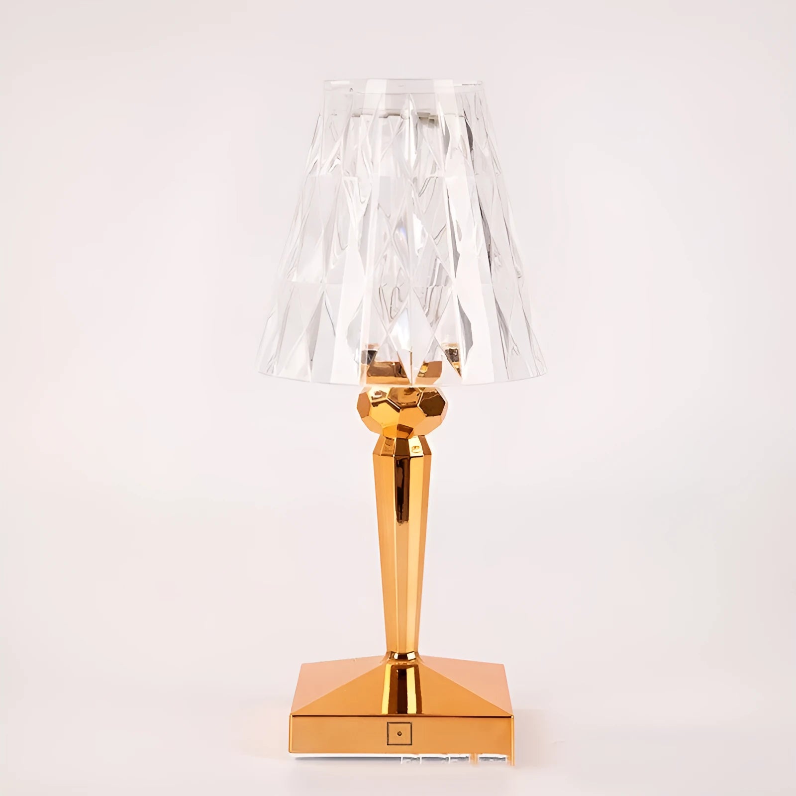 Portable rose gold touch projection night light with rechargeable battery on bedside table