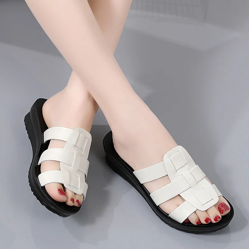 Women's flat bottom slippers in beige, black, or brown waxed PU leather with a viscose interior.