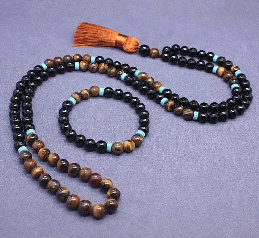 Black agate geometric bead bracelet and matching tiger-shaped tigereye stone necklace set on a grey background.