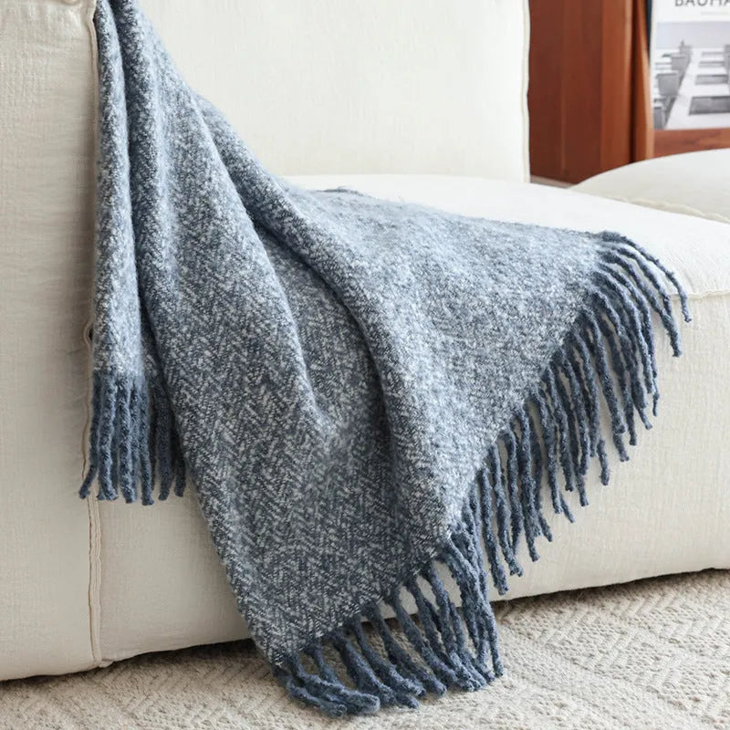 Navy blue polyester fibre leisure blanket folded on a simple sofa
