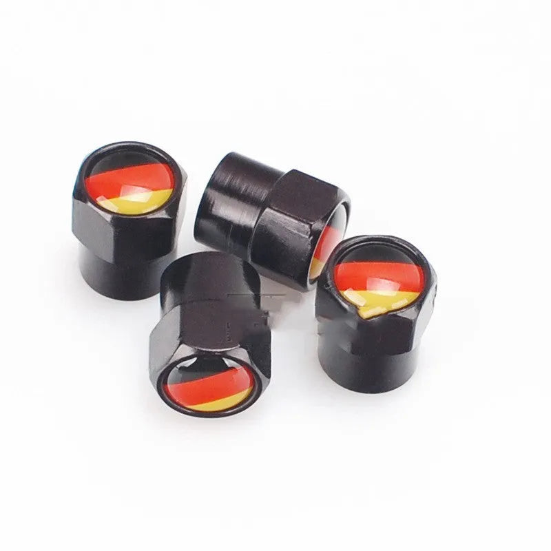 Set of four black metal aluminium alloy valve caps with German flag design on white background