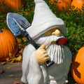 Christmas garden ornament with pipe dwarf holding smoking shovel, plastic and resin construction
