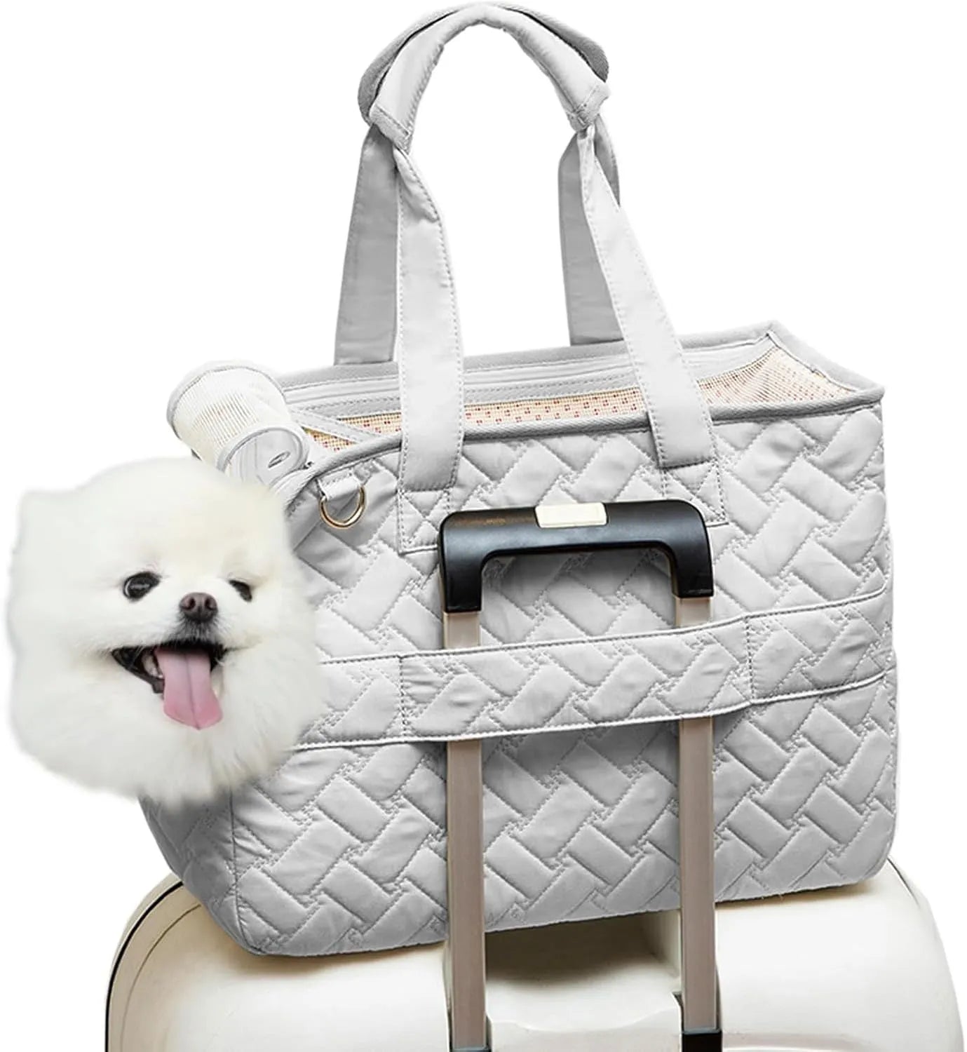 Grey pet carrier handbag with mesh panels and shoulder strap on a table