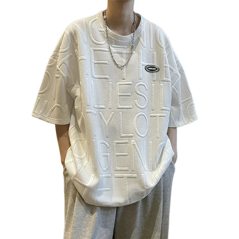 Men's grey short sleeve T-shirt with a raised 3D white letter print in a loose, retro style.