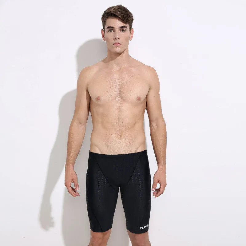 Men's black five-piece swimming set showing trunks, goggles, cap, ear plugs, nose clip, and storage bag