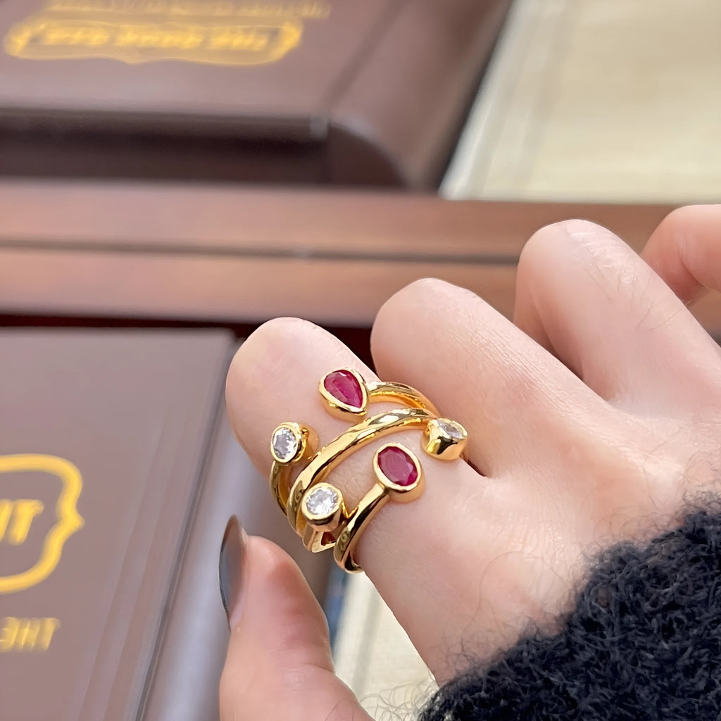 Double-headed geometric ring with irregular cross design in two-tone colours