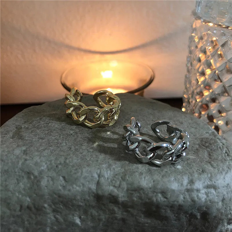 Golden aluminium alloy adjustable geometric ring chain on white background