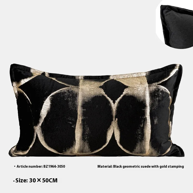 Black and gold abstract pattern decorative cushion cover on a grey sofa.
