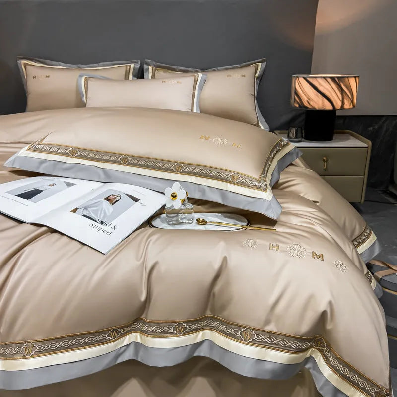 All-cotton light luxury four-piece bedding set with embroidery, available in multiple colours, on a bed