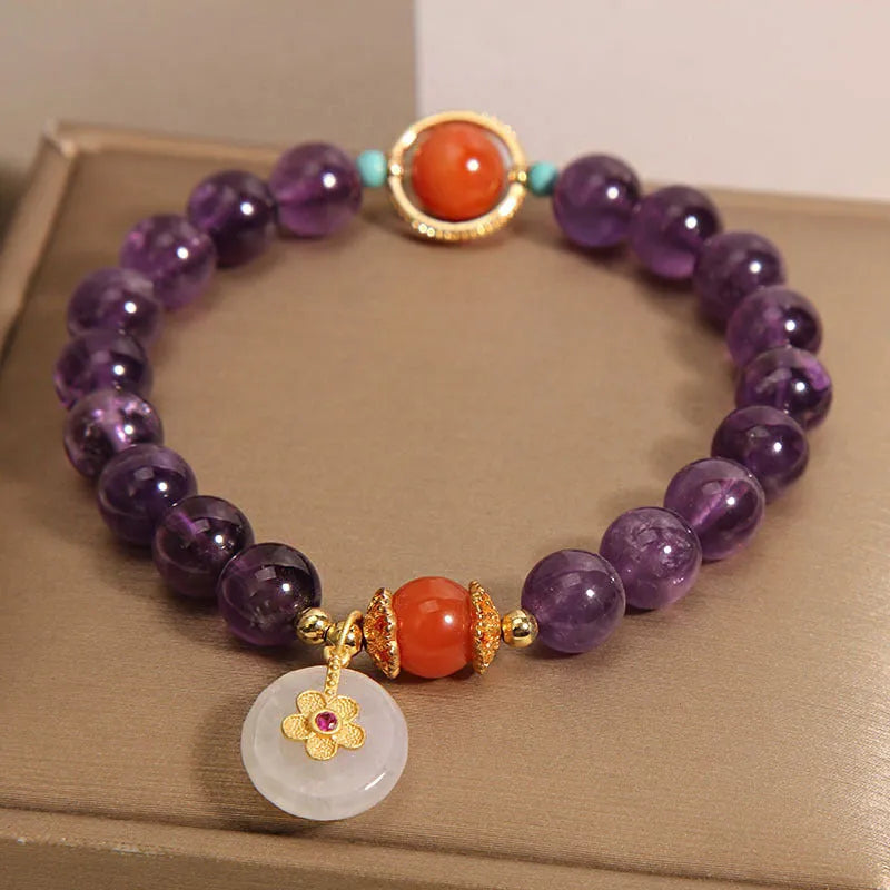Natural amethyst bracelet with sliding knot and small flower inlay on a white background