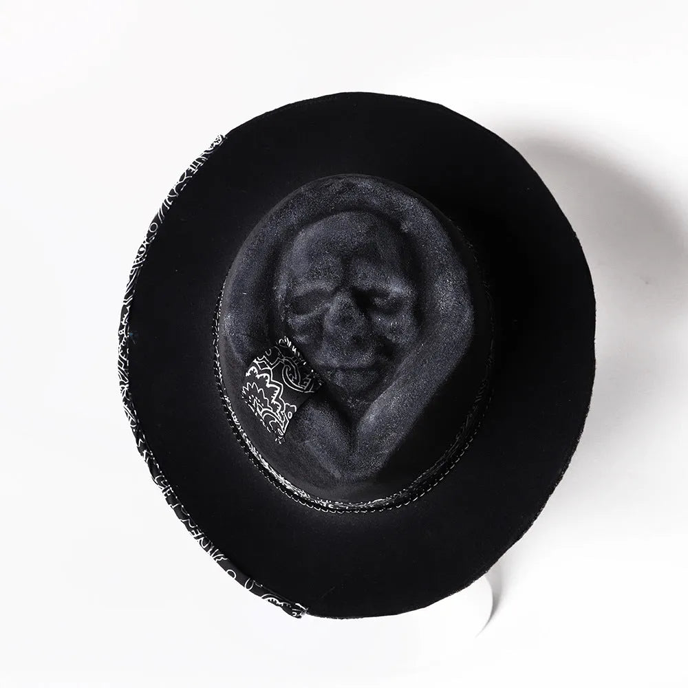 Handmade wool skull hat with conical crown and black and white embroidery for Halloween costumes.