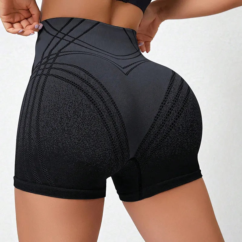 Women's high waisted gradient fitness shorts in black, shown for yoga or running.