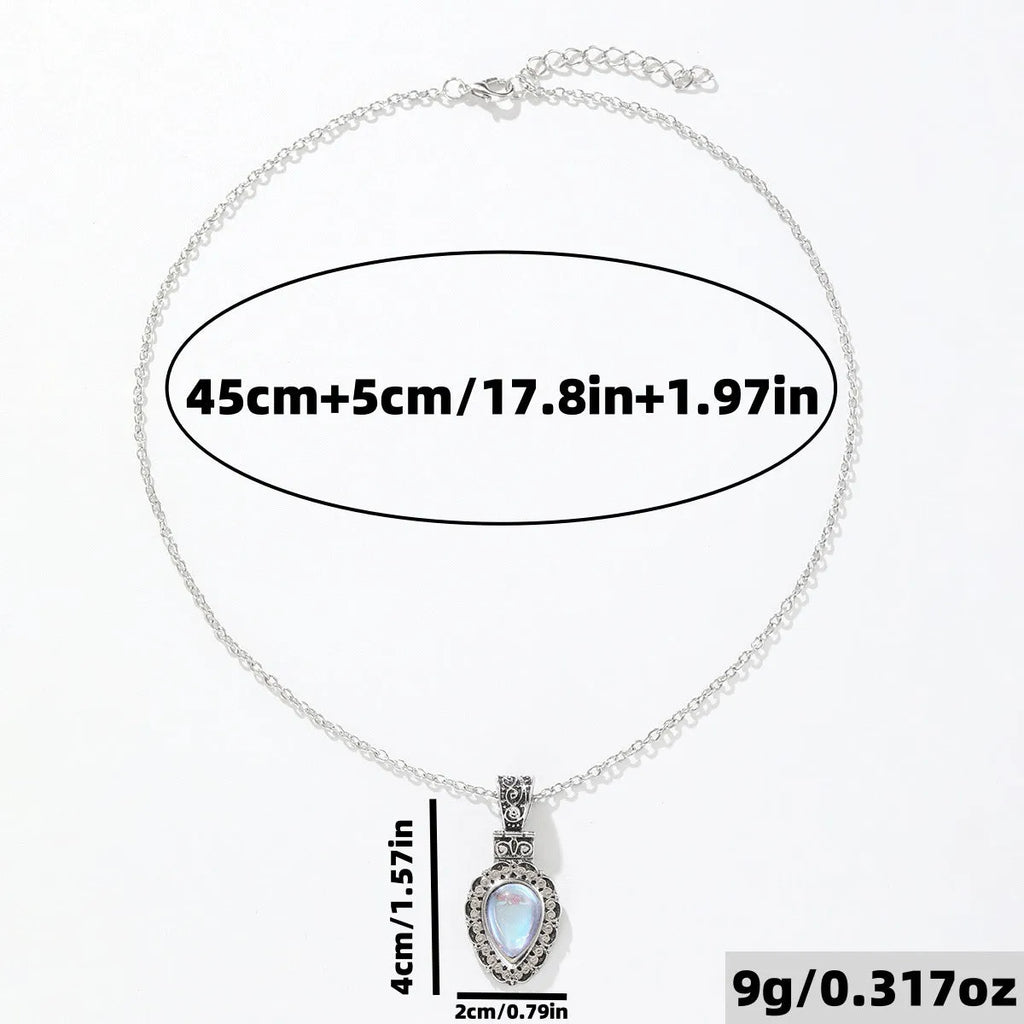 Silver heart-shaped moonstone drop necklace on a white background