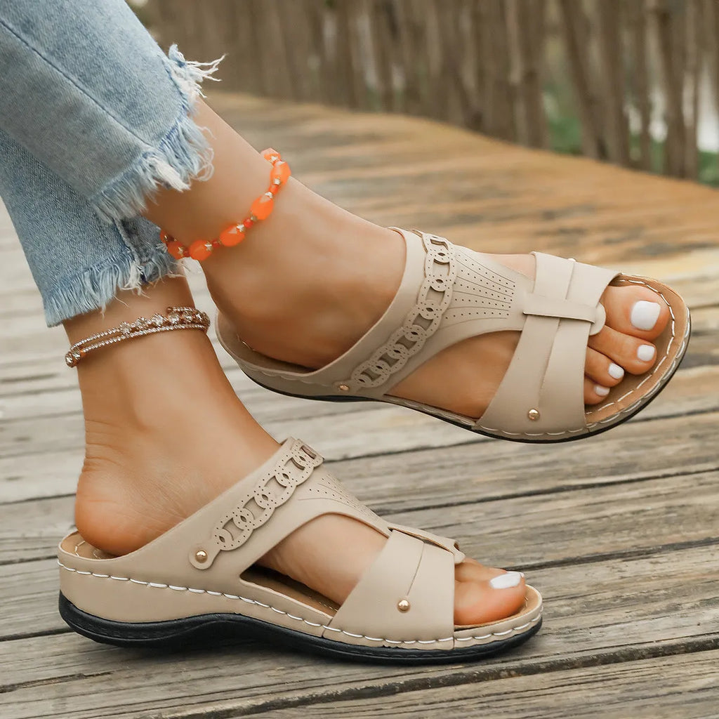 Blue roman style slippers with fish mouth toe and slope heel on a rubber sole.