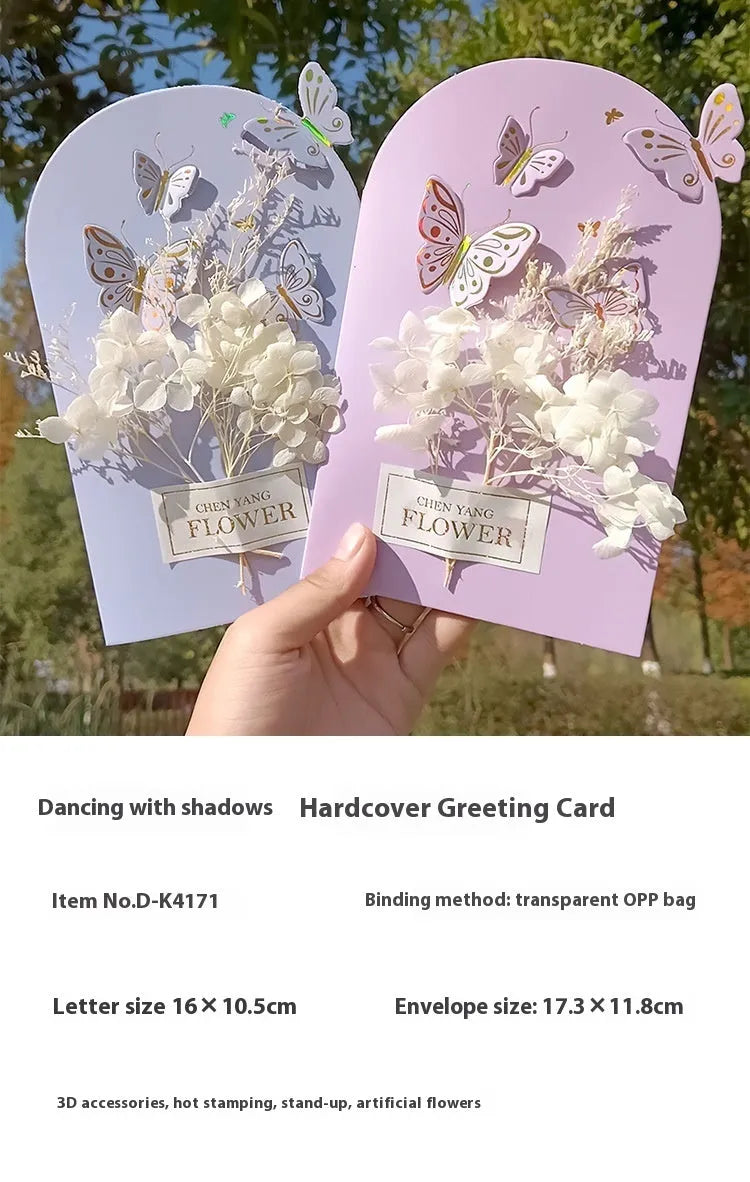 Handmade 3D boxed greeting card with butterfly shape, hot stamping, and artificial flowers on coated paper.