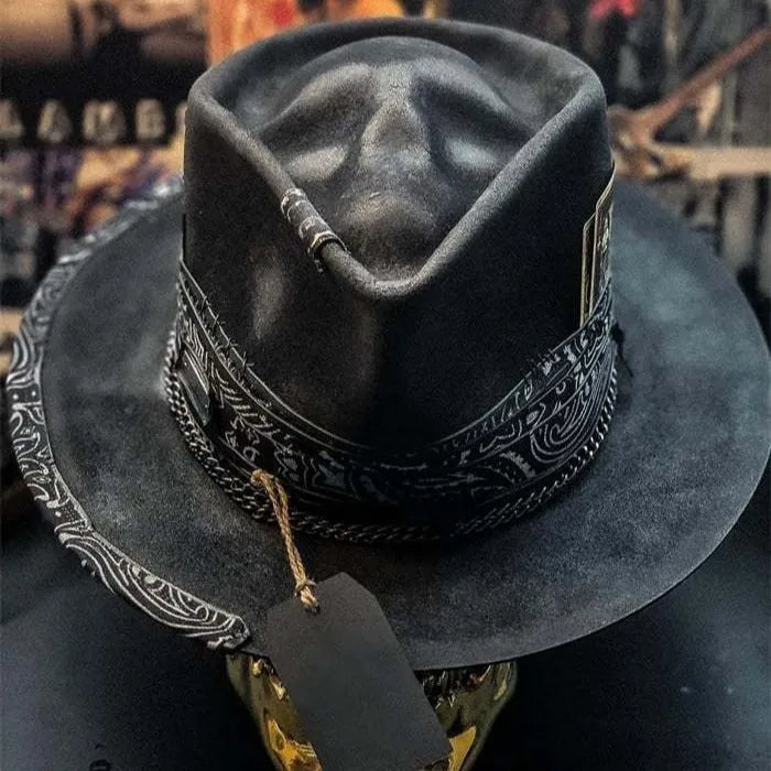 Handmade wool skull hat with conical crown and black and white embroidery for Halloween costumes.