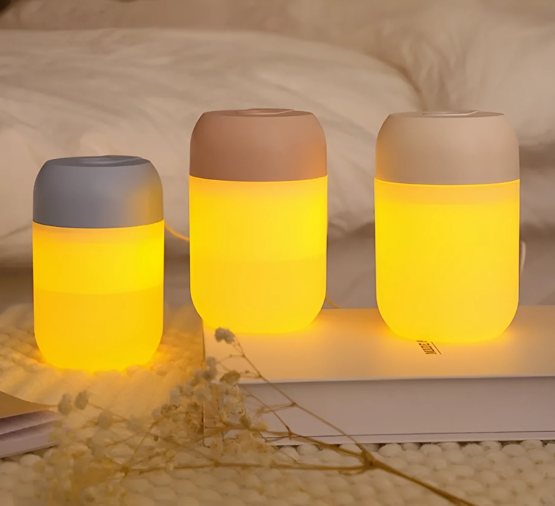 Small white cylindrical USB humidifier with aromatherapy function on a wooden desk.
