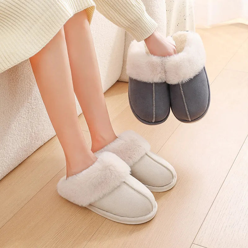 A pair of brown plush winter slippers with a round toe, flat heel, and non-slip PVC sole.