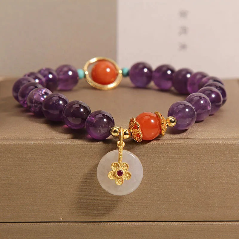 Natural amethyst bracelet with sliding knot and small flower inlay on a white background