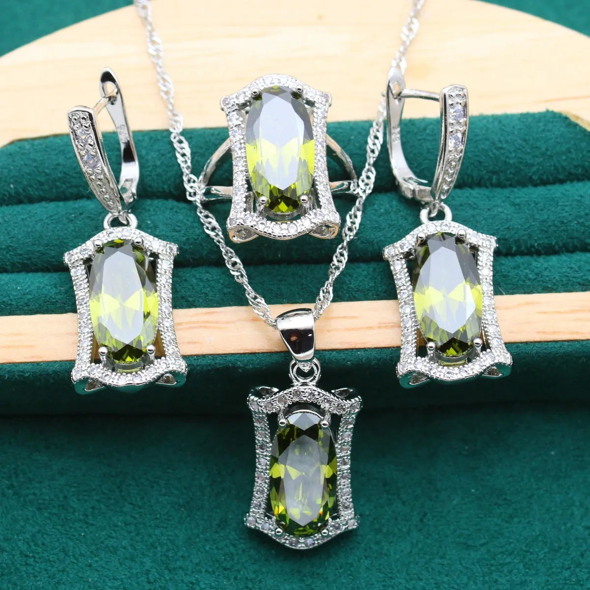 Yellow and olive alloy zircon jewellery set for women showing necklace, earrings, ring, and bracelet on display.