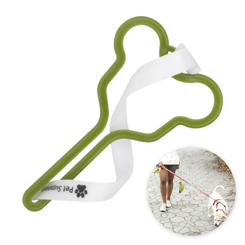 A hands-free dog waste bag holder with a fixed clip and adjustable Velcro strap attached to a pet leash.
