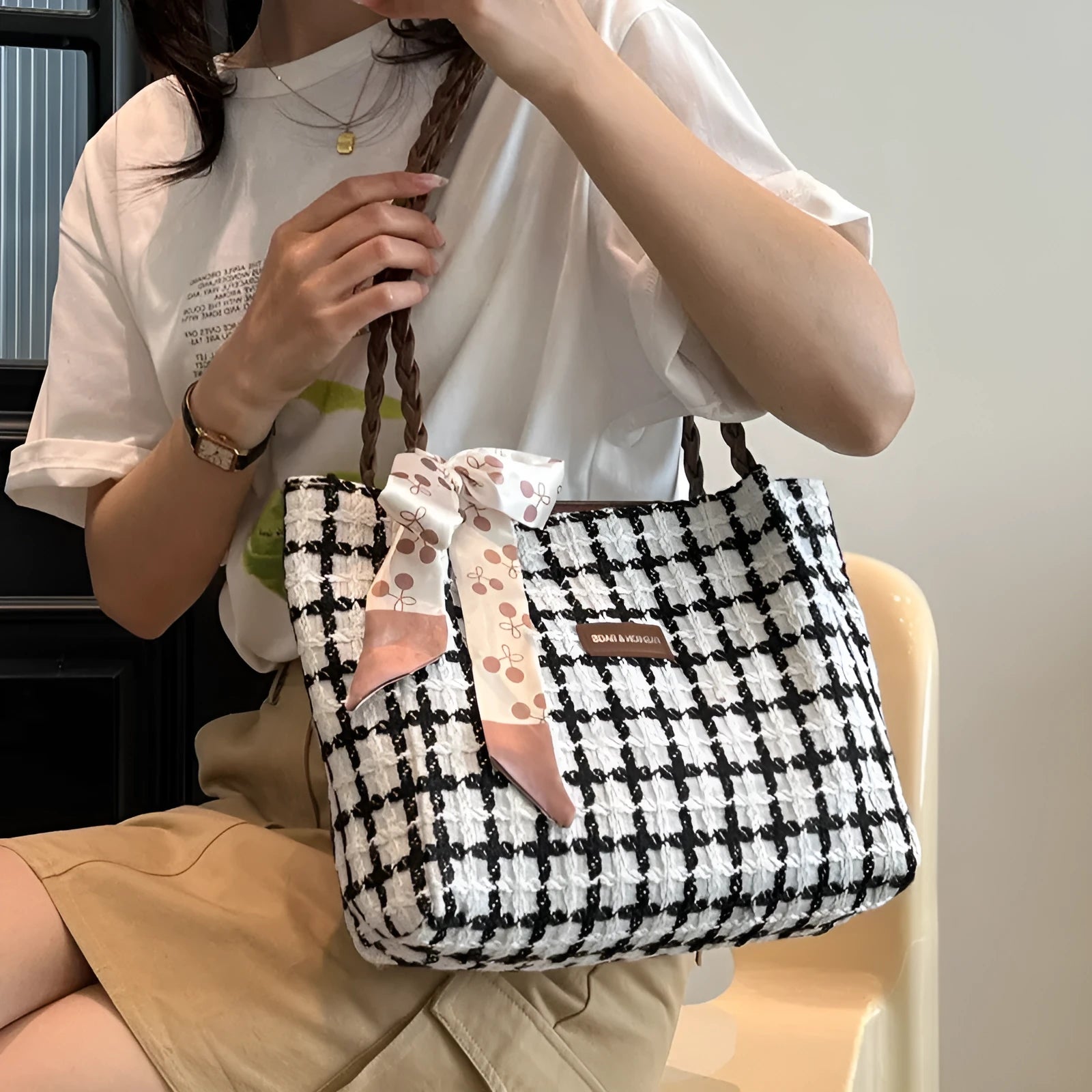 Black wool blend horizontal square shoulder bag with internal compartments for commuting and shopping