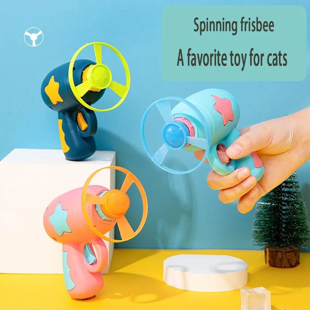 Blue interactive cat toy gun with plastic Frisbee mounted on launch mechanism