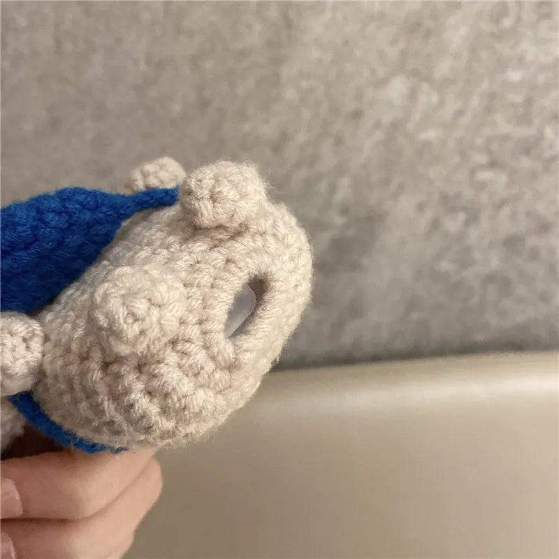 Handmade knitted AirPods protective cover with backpack koala bear design showing front and side views