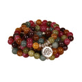 Close-up of a multi-layer beaded bracelet with 108 alloy beads and a central lotus pendant in a tourmaline colour.