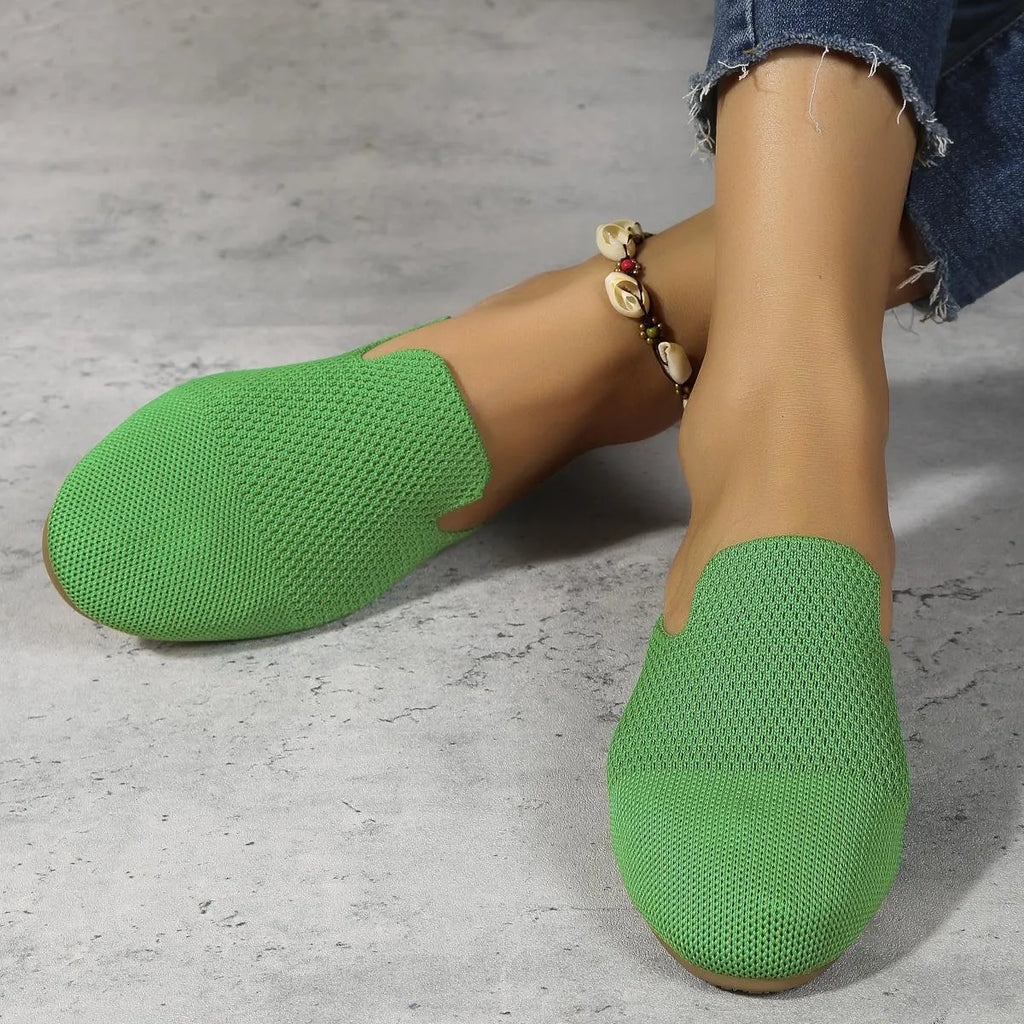 Mesh slip-on sandals in apricot, blue, and green with a cloth upper and flat rubber sole.