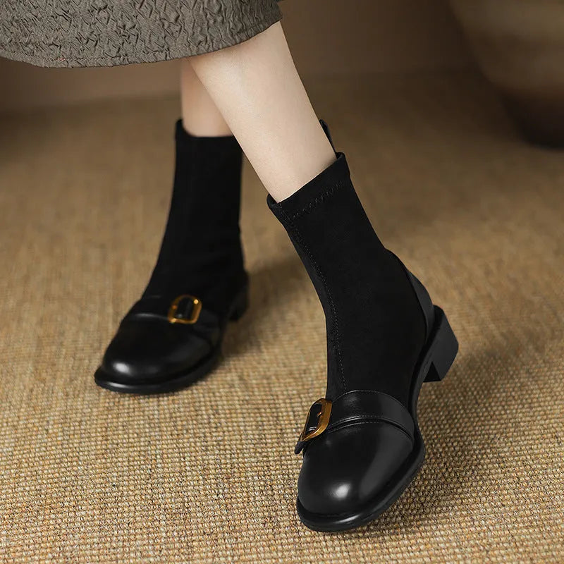 Women's black low-heel Martin ankle boots with buckle stitching and lace-up front.