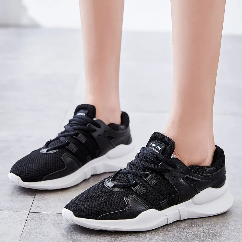 Breathable hollow-out mesh sneakers in black on a white background.