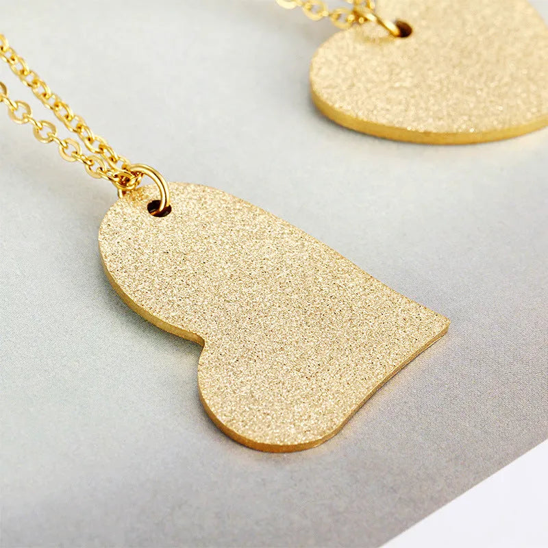 Geometric heart-shaped titanium steel pendant necklace on model
