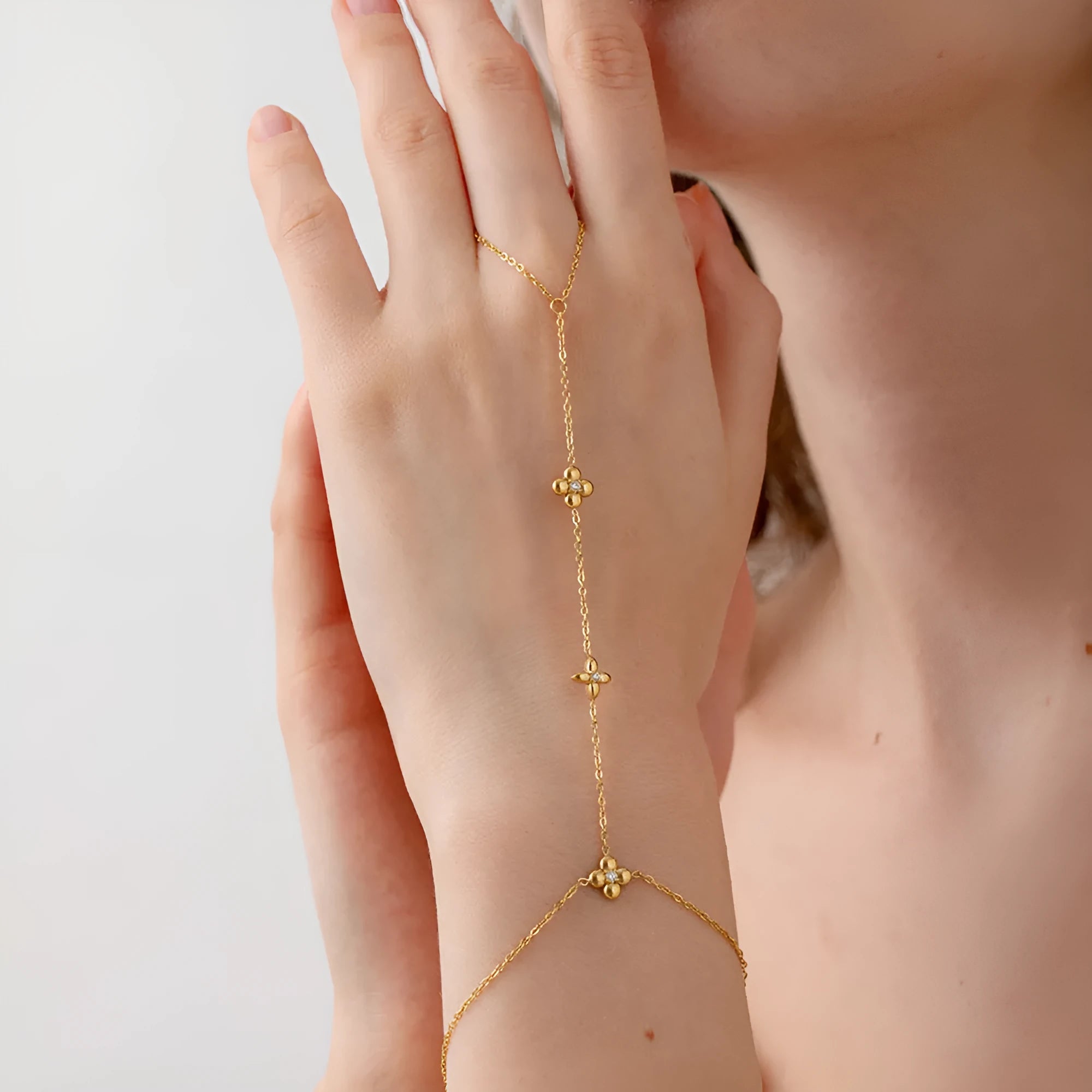 Gold stainless steel bracelet with eight pointed star and flower charms
