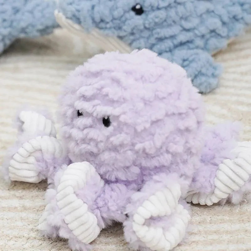 Plush caterpillar fabric dog toy in shark shape with squeaker on white background
